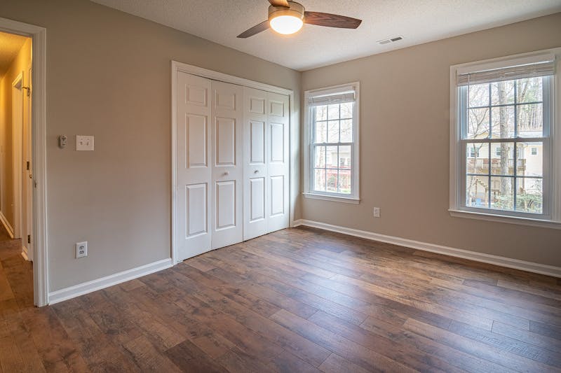 Spacious living room with freshly refinished oak hardwood floors and natural light